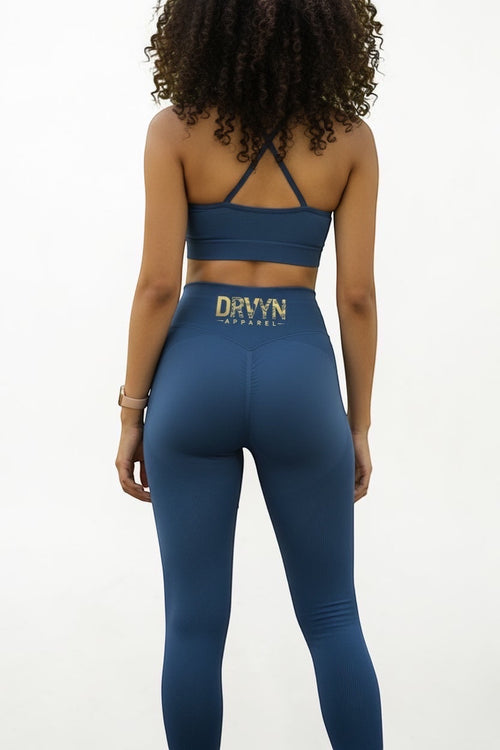 Drvyn Apparel blue high-waisted performance leggings with a sculpted fit and ribbed texture. Made from nylon and spandex.